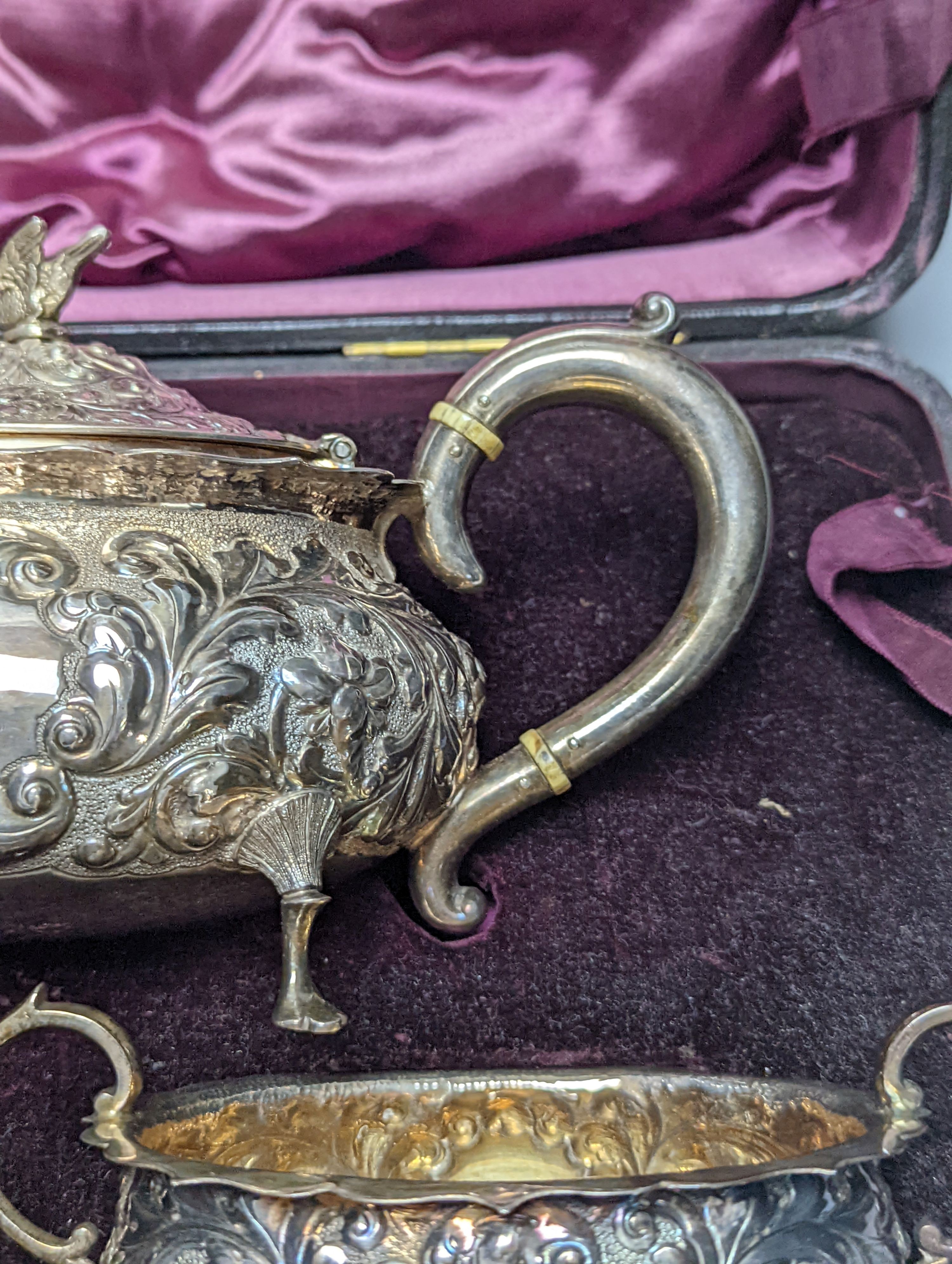 A cased late Victorian Scottish repousse silver three piece tea set, Hamilton & Inches, Edinburgh, 1897, gross 21.5oz.